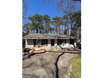 Cozy single-story home featuring a simple design, and a well-worn driveway leading to the entrance at 3382 Phillips Cir, Decatur, GA 30032