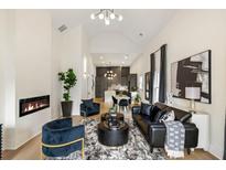 Open-concept living room features modern fireplace, stylish decor, and seamless flow to the kitchen at 1041 Walker Se Ave, Atlanta, GA 30316