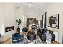 Elegant living room features a modern fireplace, stylish furniture, and an open layout with kitchen view at 1041 Walker Se Ave, Atlanta, GA 30316