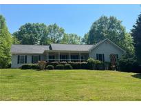 Charming ranch-style home with a welcoming front porch and well-maintained landscaping at 6365 Mountain View Trl, Cumming, GA 30041
