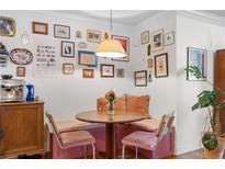 Cozy breakfast nook with unique gallery wall, built-in seating, and hardwood floors at 885 Briarcliff Ne Rd # 16, Atlanta, GA 30306
