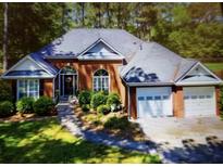 Charming brick home with an attached garage and mature landscaping at 97 Old Burnt Hickory Rd, Acworth, GA 30101