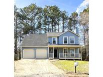 Charming two-story home with a welcoming front porch and a well-maintained two-car garage at 2196 Sandell Sw Trl, Marietta, GA 30008