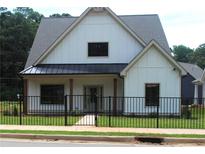 Charming single-Gathering home featuring a modern farmhouse design with a black metal fence and lush green lawn at 127 Old Alabama Se Rd, Emerson, GA 30137