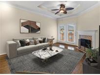 Bright living room features a fireplace, fan, and glass doors to a balcony, with a marble coffee table at 10 Perimeter Summit Ne Blvd # 2405, Atlanta, GA 30319