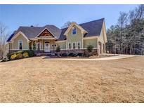 Charming exterior elevation with an inviting entryway, complemented by a lush landscaped yard and two-car garage at 100 Walnut Ridge Ct, Covington, GA 30014