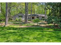 Charming single-story home featuring well-maintained landscaping and a natural setting at 1959 Grand Prix Ne Dr, Atlanta, GA 30345