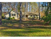 Charming single story home with mature trees and a well-maintained lawn at 1959 Grand Prix Ne Dr, Atlanta, GA 30345