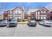 Inviting two-story condo complex with parking spaces in front of each unit in a well-maintained community at 818 Dunes Way # 818, Alpharetta, GA 30022
