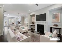 Bright living room featuring a fireplace, modern decor, and seamless open-concept design at 1829 Hislop Ln, Atlanta, GA 30345