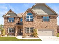Charming two-story brick home with well-manicured lawn and inviting curb appeal at 3314 Ridge Manor Way, Dacula, GA 30019