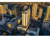 Stunning aerial view of downtown buildings, showcasing the building's rooftop pool and surrounding cityscape at 860 Peachtree St # 1418, Atlanta, GA 30308