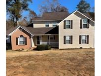 Inviting two-story home featuring a charming front porch and beautiful curb appeal at 501 Owens Springs Ln, Mcdonough, GA 30252