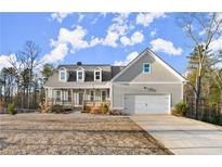 Charming two-story home with a covered front porch and attached two-car garage at 411 Spring Lake Hls, White, GA 30184