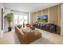 Bright living room featuring a stylish brown sectional sofa and a modern entertainment center at 2437 Red Maple Se Xing # 122, Smyrna, GA 30080