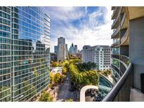 Stunning city views from the private balcony of this high-rise condo featuring modern architecture at 1080 Peachtree Ne St # 1208, Atlanta, GA 30309