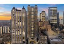 Stunning high-rise condo building with beautiful architecture against a vibrant sunset sky at 195 14Th Ne St # 2105, Atlanta, GA 30309