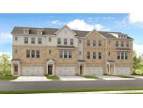 Charming townhome features a brick facade, attached garages, and professionally landscaped grounds at 3194 Eastham Run Dr, Dacula, GA 30019