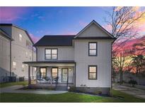 Charming two-story home with a welcoming front porch and modern design elements set against a vibrant sunset at 2357 Lynn Iris Dr, Decatur, GA 30032