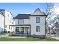 Charming two-story home with a covered front porch and modern farmhouse-style vertical siding at 2357 Lynn Iris Dr, Decatur, GA 30032