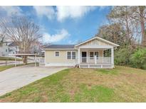 Charming single-story home with a welcoming front porch and covered parking on a grassy lot at 346 Henry Aaron Sw Ave, Atlanta, GA 30310