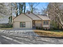 Charming single-Gathering home with a well-maintained front yard, attached garage, and inviting entrance at 649 Woodcrest Manor Dr, Stone Mountain, GA 30083