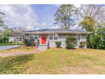 Charming single-story home with gray siding and a vibrant red front door at 2818 Mcafee Rd, Decatur, GA 30032