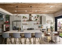 Modern kitchen boasts stainless steel appliances, a spacious island, and stylish wood ceiling at 890 Memorial Se Dr # 101, Atlanta, GA 30316
