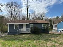 Single-story home with neutral siding, a simple front yard, and a covered front porch, ready for renovation at 2298 Swallow Se Cir, Atlanta, GA 30315