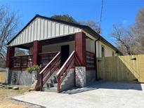 Newly renovated exterior with modern siding, covered porch and gray stone accents at 624 S Grand Nw Ave, Atlanta, GA 30318