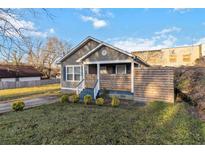 Charming one-story home with a well-manicured lawn and modern wood fence at 660 Simmons St, Atlanta, GA 30318
