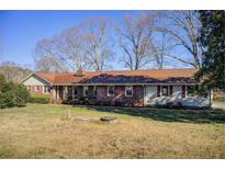 Charming single-story home with red shutters and a spacious front yard at 5010 Highway 20 Ne, Conyers, GA 30012