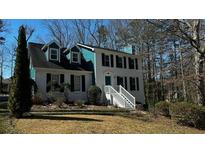 Charming two-story home featuring a painted brick facade, white stairs, and blue accents at 3052 Glynn Mill Dr, Snellville, GA 30039