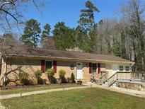 Charming ranch-style home with a well-manicured front yard and a welcoming entrance with red shutters at 4536 Amy Rd, Snellville, GA 30039