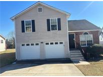 Charming two-story home featuring a two-car garage and a combination of siding and brick facade at 870 Pine Shoals Dr, Atlanta, GA 30349