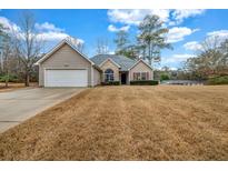 Charming single-story home with a two-car garage, well-kept lawn, and inviting curb appeal at 2327 Maple Ave, Morrow, GA 30260