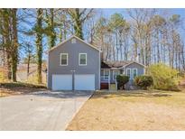 Charming home with a two-car garage and a well-maintained front yard at 6265 Stoney Cv, Austell, GA 30168