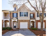 Charming townhome with brick facade, blue shutters, attached garage, and inviting front entrance at 2873 Snapfinger Mnr, Decatur, GA 30035