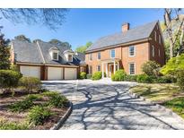 Beautiful brick home with a three car garage and paved driveway at 2980 Bakers Meadow Se Ln, Atlanta, GA 30339