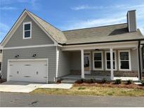 Charming single-Gathering home with a two-car garage, covered porch, and neutral gray siding and roof at 241 Saratoga Dr, Acworth, GA 30102