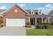 Charming brick home featuring a well-maintained front yard and a two-car garage at 2975 Thistle Trl, Suwanee, GA 30024