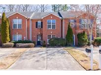 Brick townhome showcasing a well-kept lawn and a private driveway for easy access and curb appeal at 3326 Waldrop Trl, Decatur, GA 30034