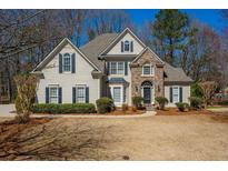 Charming two-story home with manicured landscaping and a combination of siding and stone facade at 4125 Bridle Ridge Dr, Suwanee, GA 30024