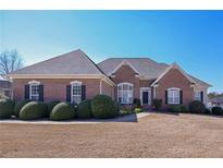 Charming brick home featuring manicured landscaping and a well-maintained lawn at 108 Jasmine Way, Villa Rica, GA 30180