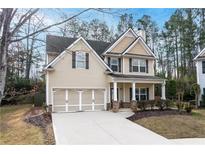 Charming two-story home with a well-maintained lawn and attached two car garage at 1558 Autumn Wood Trl, Sugar Hill, GA 30518