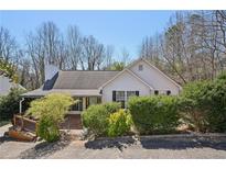 Charming one-story home featuring a gable roof, chimney, and lush landscaping at 172 Shallow Ridge Ne Ln, Kennesaw, GA 30144