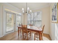 Bright dining area features a wooden table, chairs, and a modern chandelier, perfect for Gathering meals at 3777 Peachtree Ne Rd # 1007, Atlanta, GA 30319