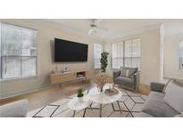 Bright living room featuring modern decor, hardwood floors, and large windows with natural light at 3777 Peachtree Ne Rd # 1007, Atlanta, GA 30319