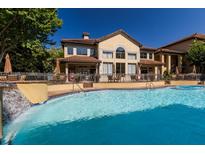 Exterior view of a sparkling pool and landscaped facade of community building on a sunny day at 3777 Peachtree Ne Rd # 1007, Atlanta, GA 30319