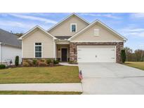 Beautiful home featuring stone accents, a well-manicured lawn, and a two-car garage at 4902 Pleasantry Way, Acworth, GA 30101